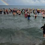 Daredevils Take the Plunge: New Year’s Day Charity Swim Returns to Arenal Beach